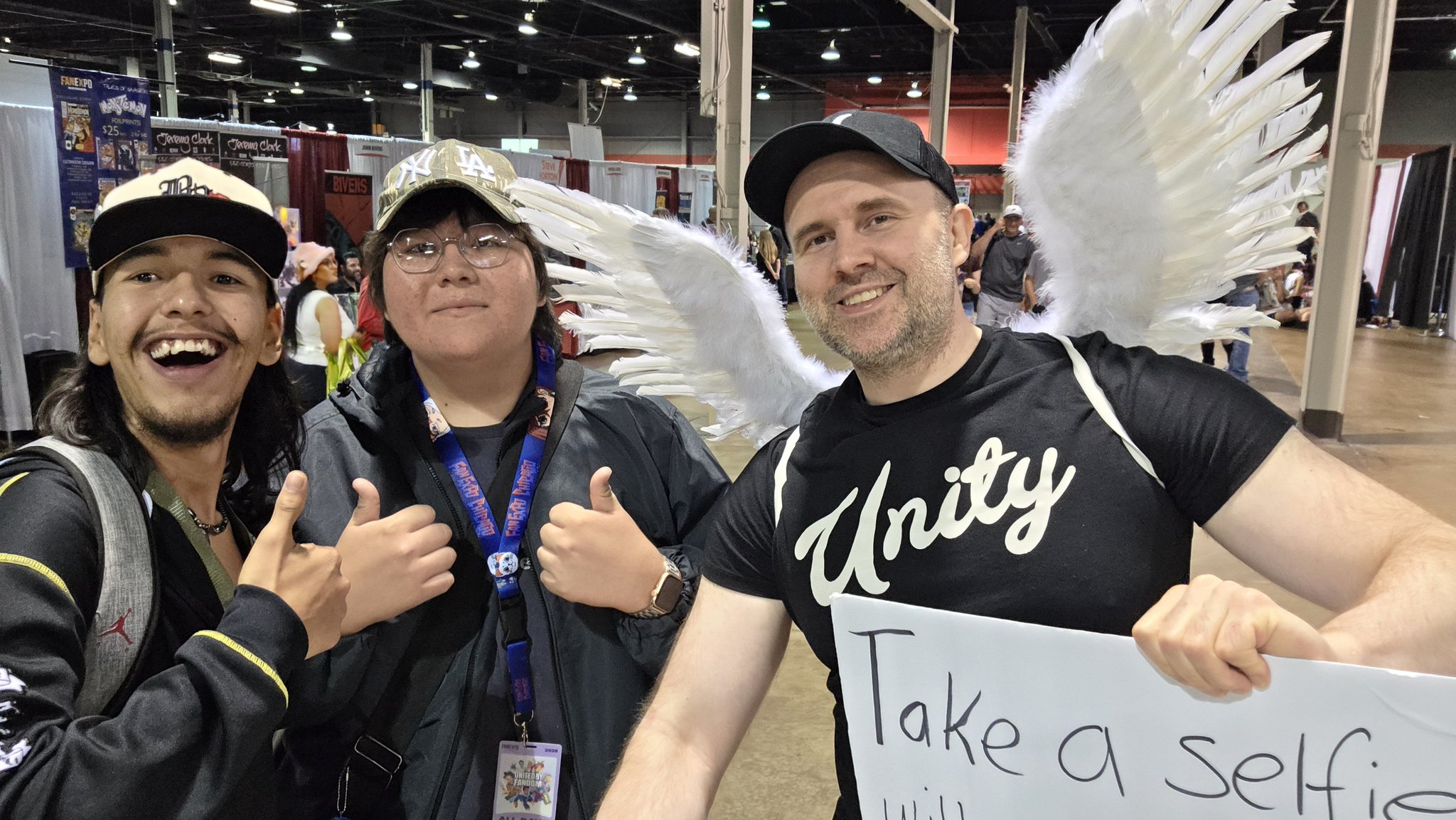 Adam taking a selfie with an attendee in a floral shirt at Fan Expo