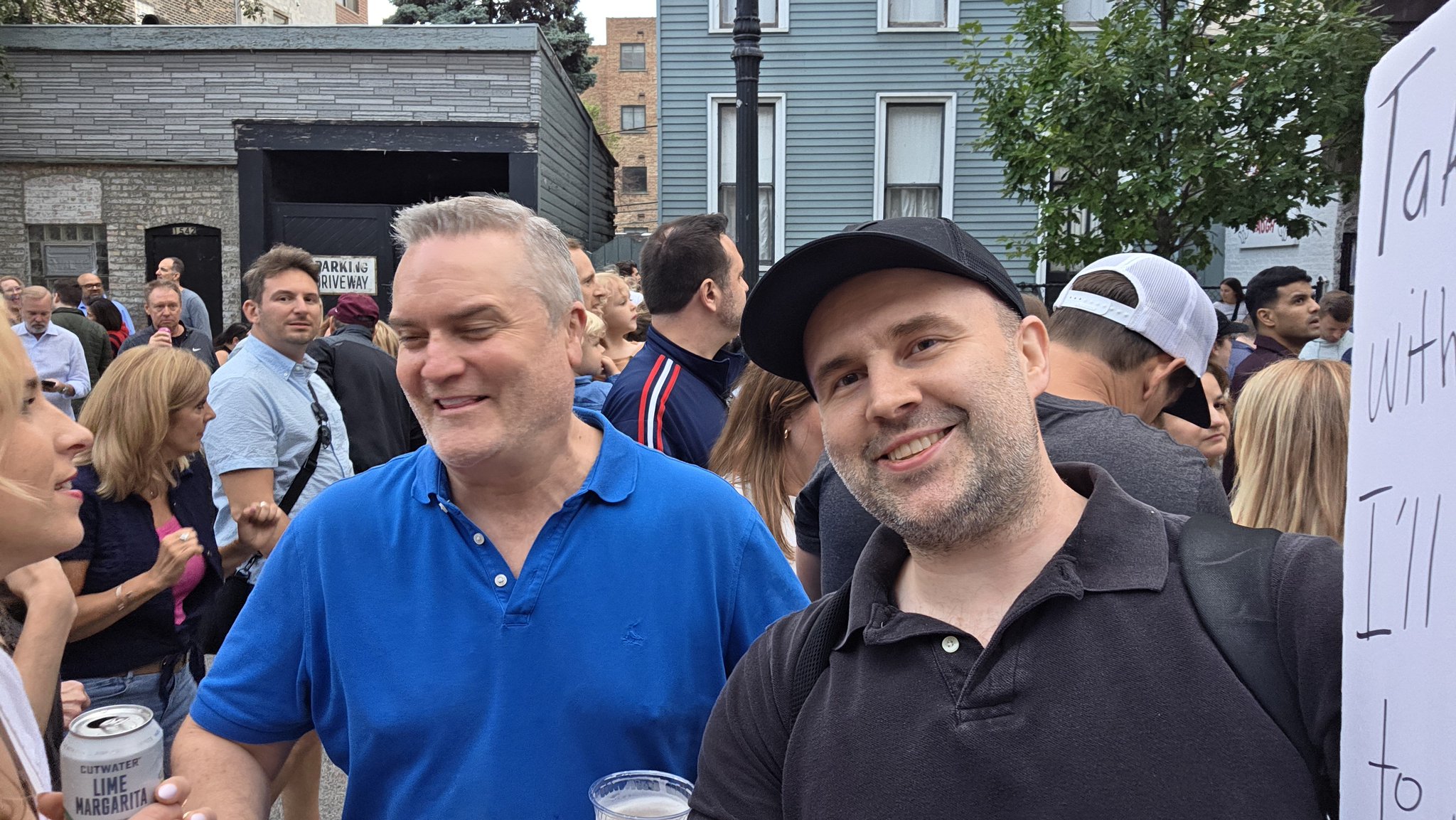 Adam taking a selfie with a festival-goer in a white blouse at Wells Street
