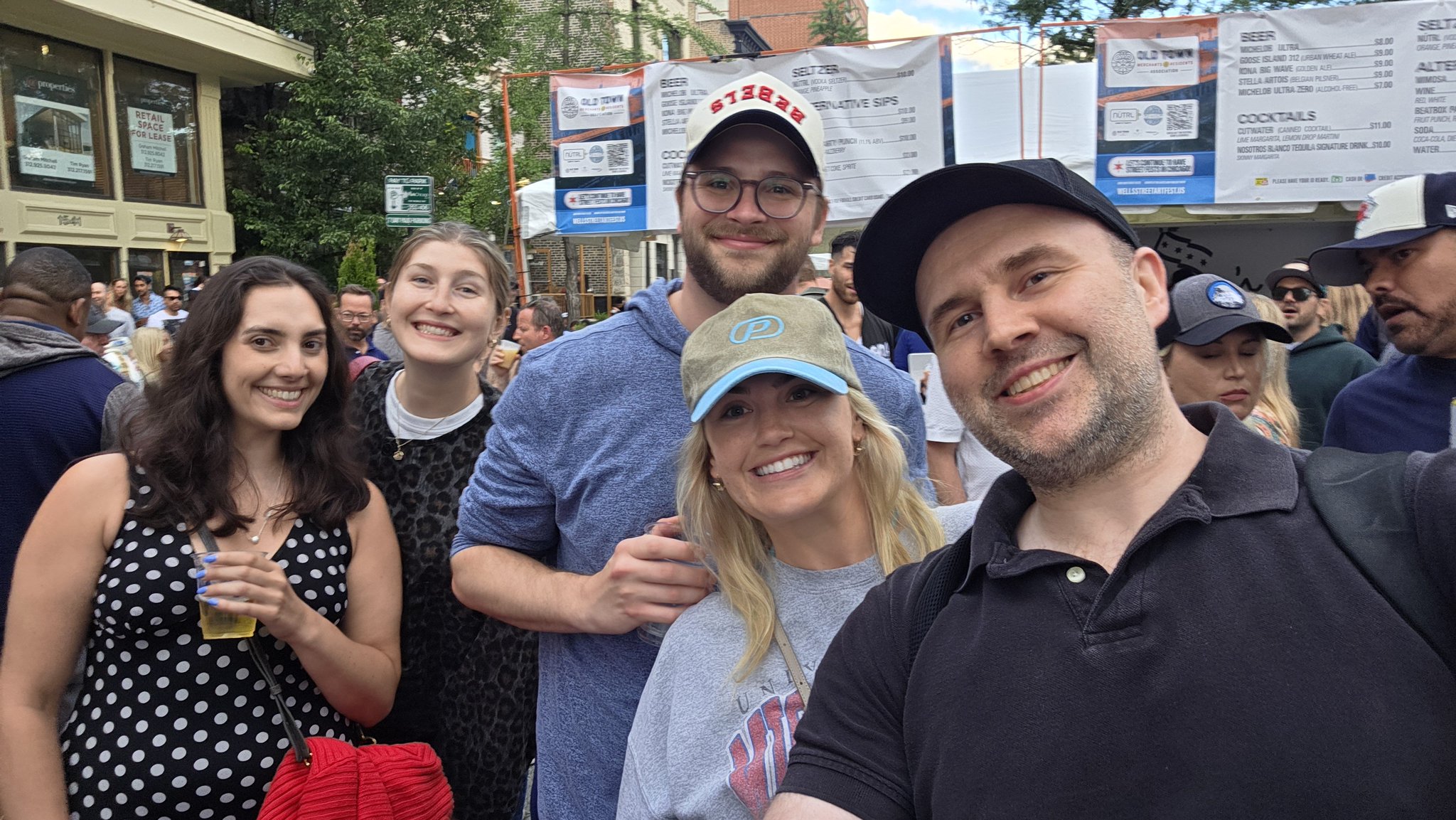 Adam taking a selfie with a festival-goer in a yellow shirt at Wells Street