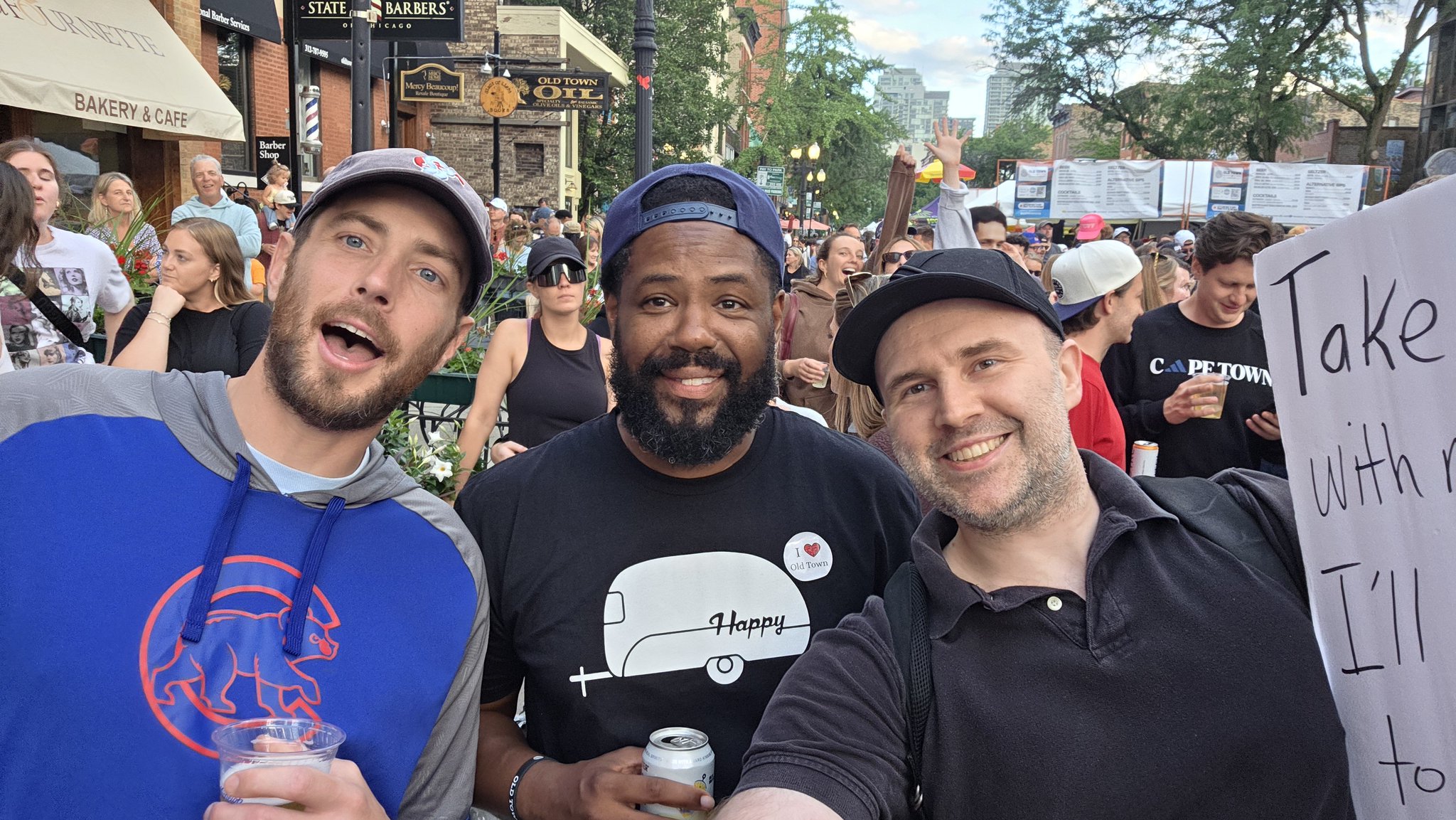 Adam taking a selfie with a festival-goer wearing a cap at Wells Street